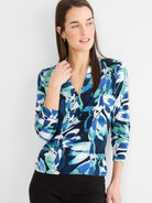 Wrap top with a V-neck, long sleeves, and an abstract leaf pattern in blue, teal, white, and black.