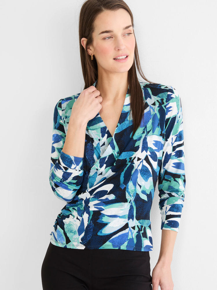 Wrap top with a V-neck, long sleeves, and an abstract leaf pattern in blue, teal, white, and black.