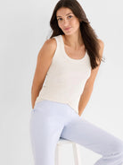 Cream rib knit scoop tank top on a woman.