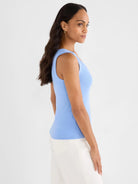 Light blue ribbed knit scoop tank top on a model.