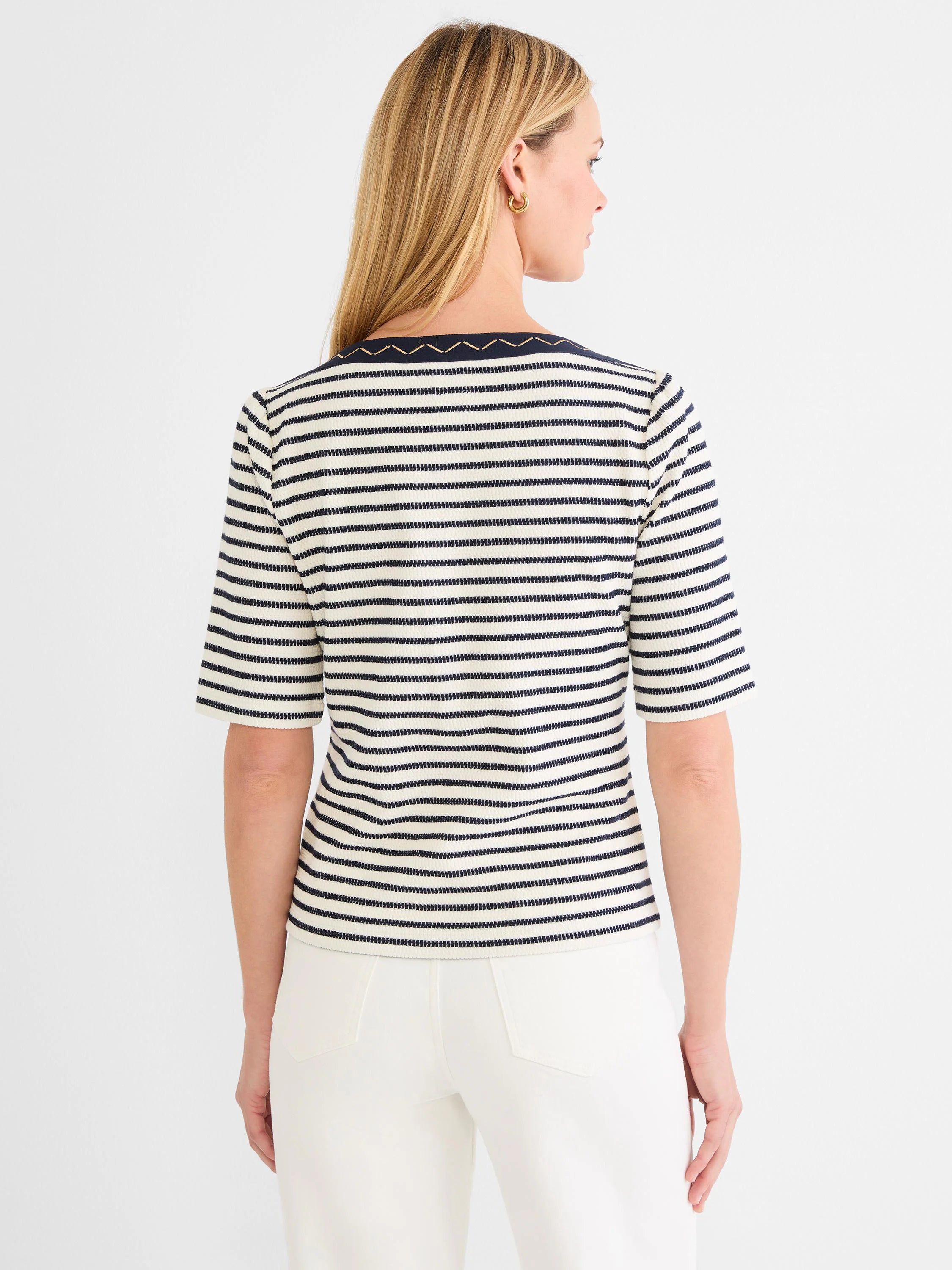 Off-white and navy striped boatneck top with short sleeves, featuring gold embroidery along the neckline.