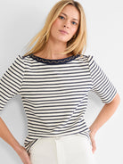 Cream & navy striped boatneck top with short sleeves, featuring a navy collar trim with gold zigzag embroidery.