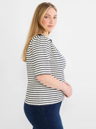Cream and navy horizontally striped boatneck top with textured embroidery and short sleeves.