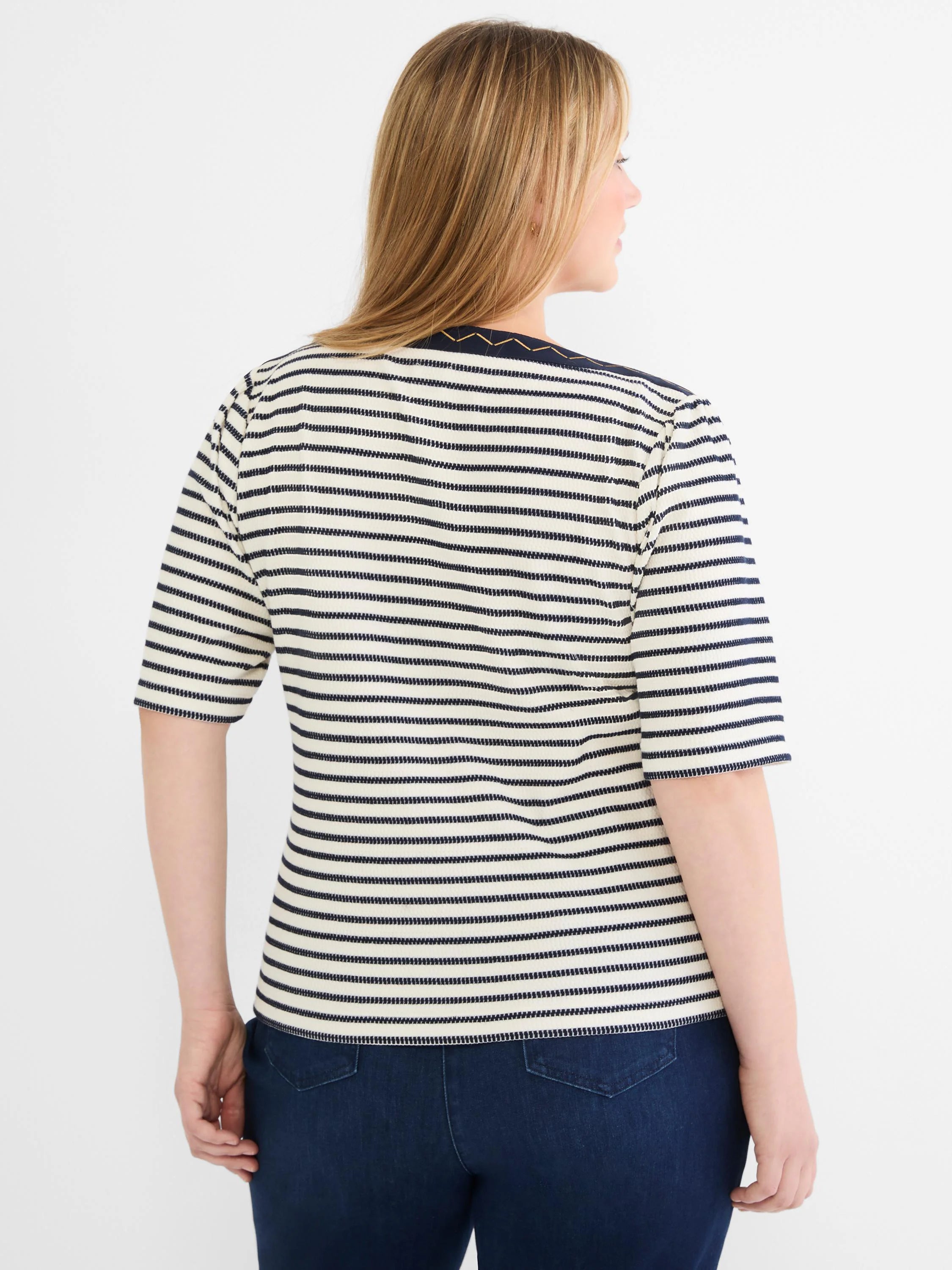 Cream and navy horizontal striped boatneck top with short sleeves. Navy neckline features gold-toned embroidery.