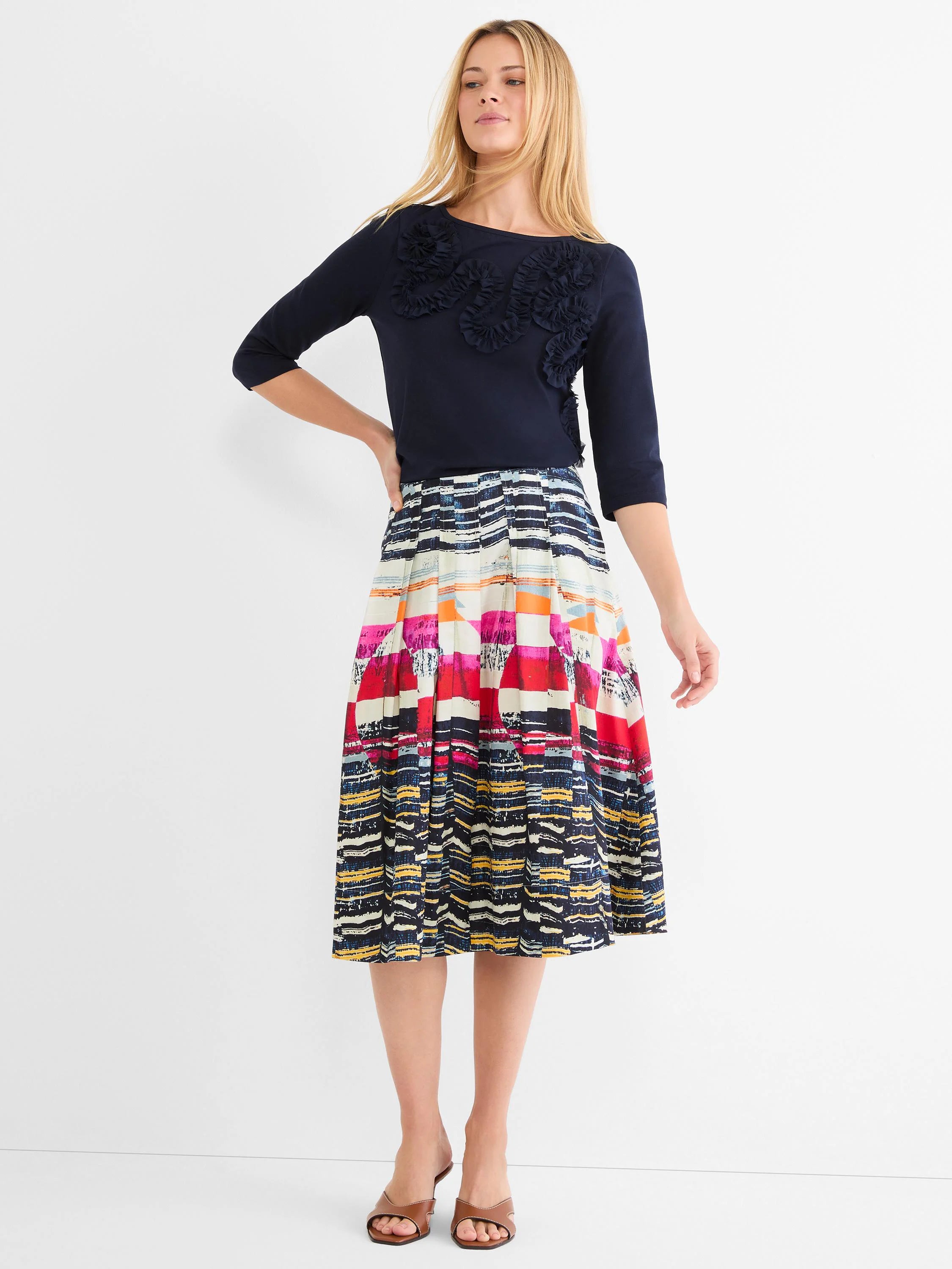 Navy blue top with 3/4 sleeves, featuring ruffled mesh appliques in a swirling pattern across the chest.
