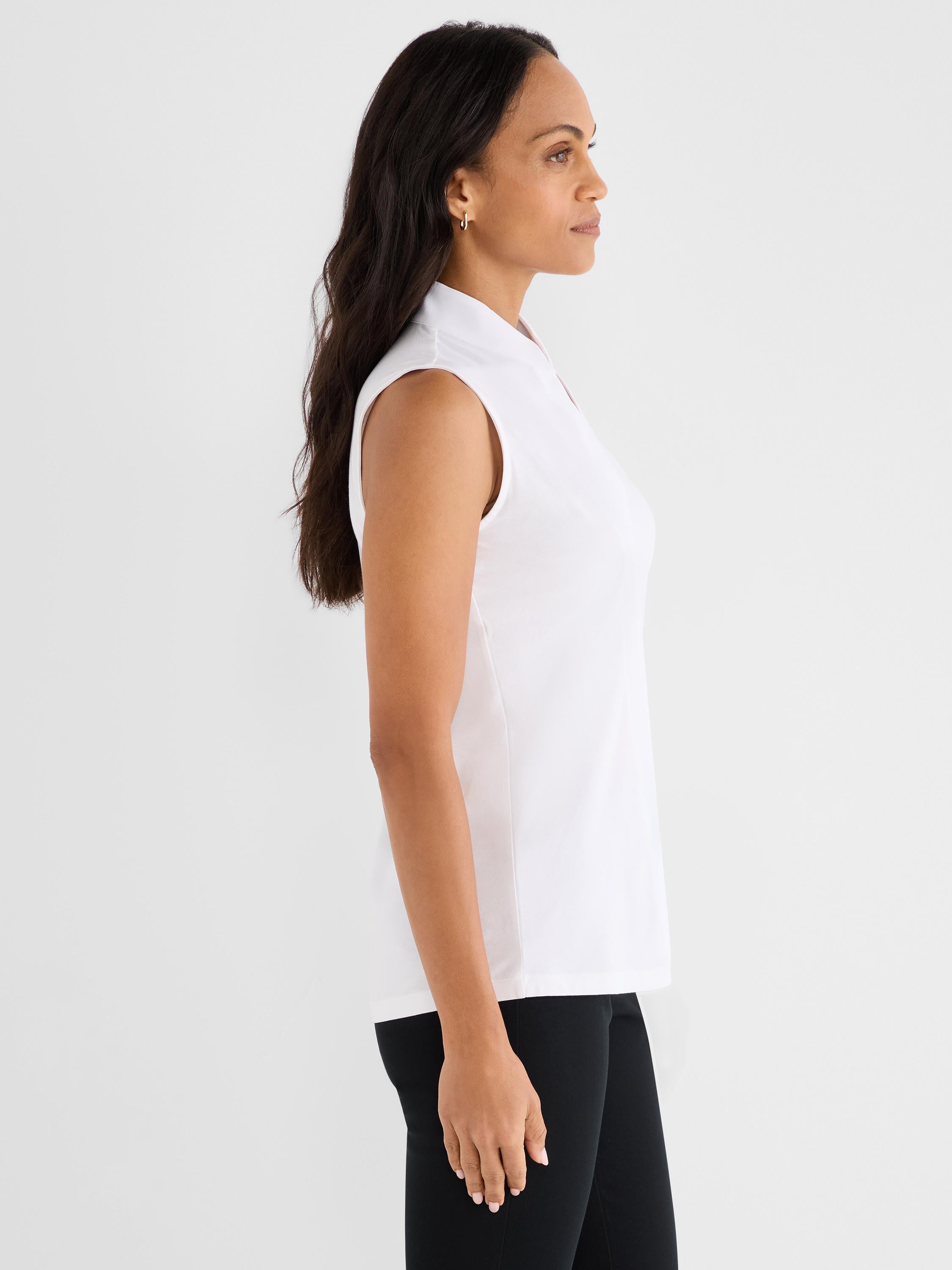White sleeveless blouse featuring a stand collar and a relaxed silhouette.