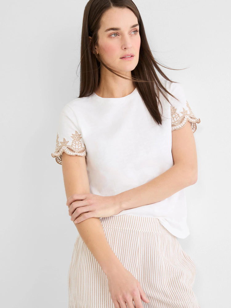 White slub cotton tee with tan embroidered, scalloped short sleeves.