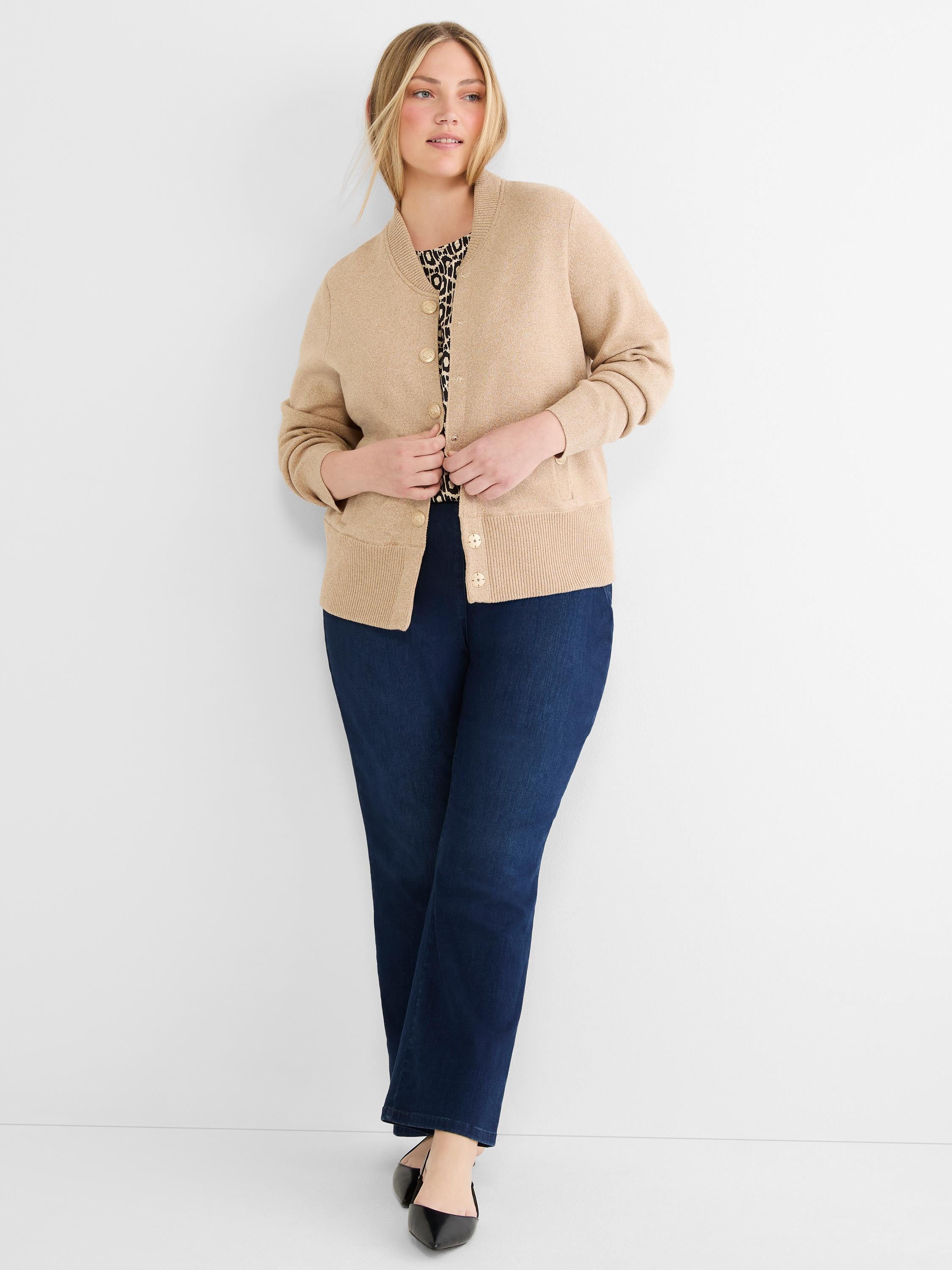 A classic-fit tan crewneck cardigan sweater with gold buttons and a ribbed hem is worn partially fastened.