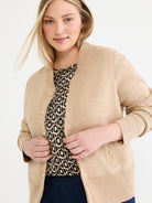 Relaxed fit tan knit cardigan jacket with a crew neck, visible texture, and shiny gold front buttons.