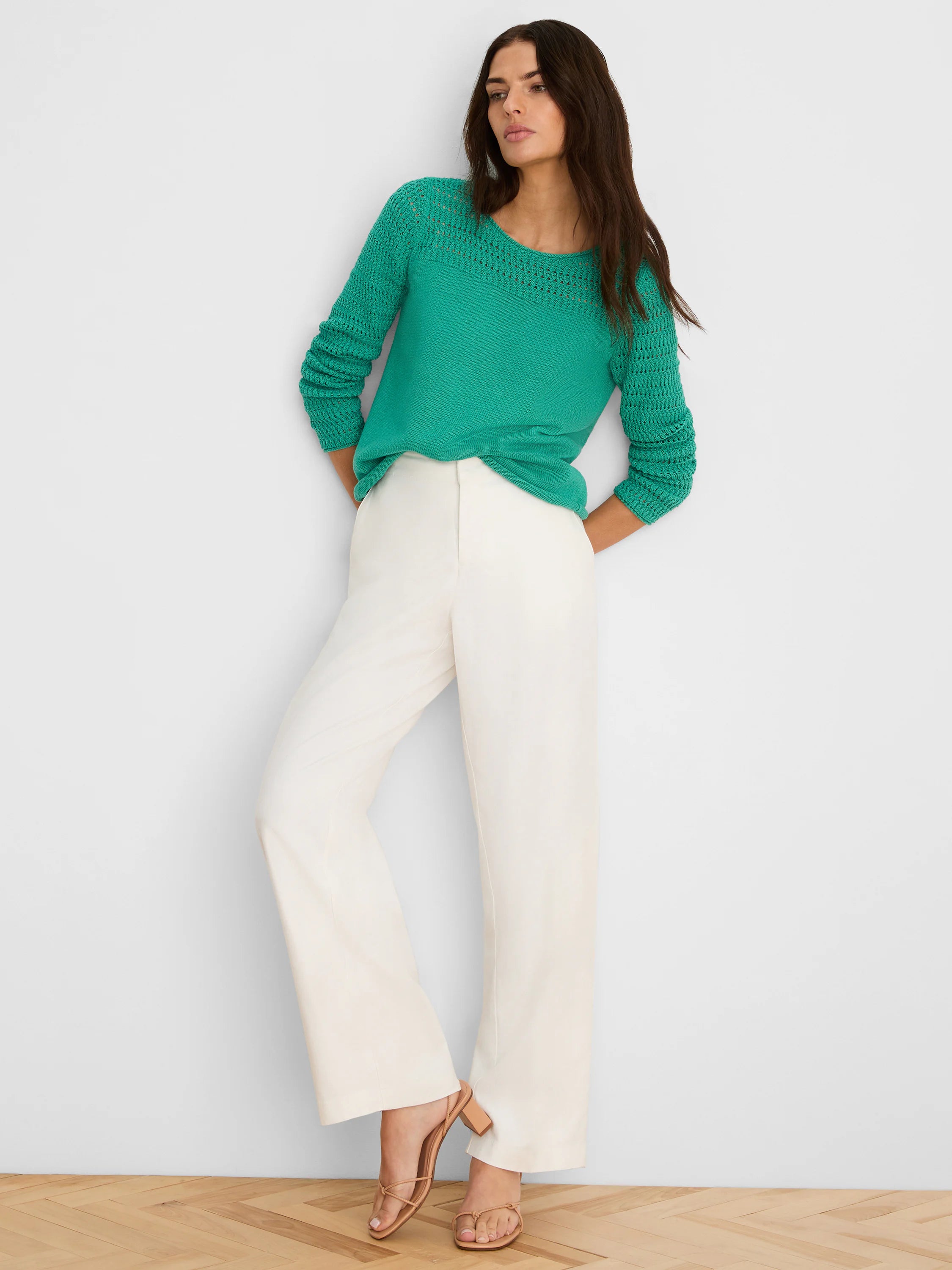 Green pointelle sweater featuring openwork knit details on the yoke and long sleeves.