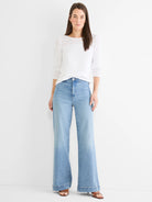 White sweater with pointelle knit details on long sleeves & shoulders, round neck.