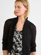 Black featherknit cardigan with sheer body and sleeves. Features an open front with ruffled edges and ribbed cuffs.