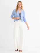 Light blue featherknit cardigan with ruffled open front, cropped fit, and 3/4 ribbed sleeves.