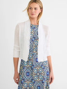 White featherknit cardigan with open front, ruffled vertical panels, and 3/4 ribbed sleeves.