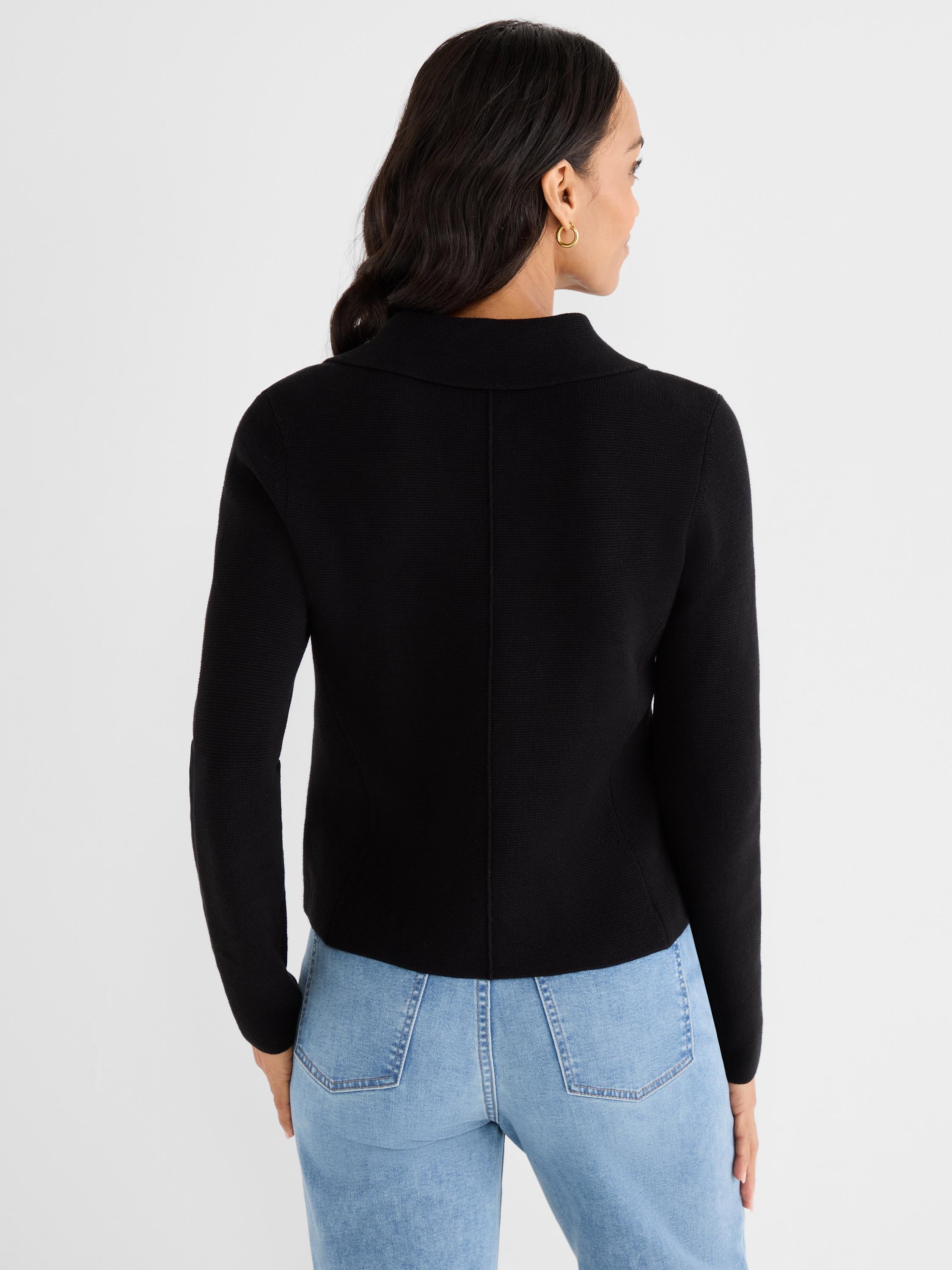 Fitted black knit cardigan features long sleeves, a standing shawl collar, and a center back seam.