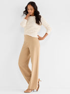 Ivory wave-pattern knit pullover with three-quarter sleeves paired with tan high-rise wide-leg pants.