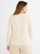 Neutral long-sleeve sweater in a standard fit featuring a cream and tan bicolor wavy open knit design.
