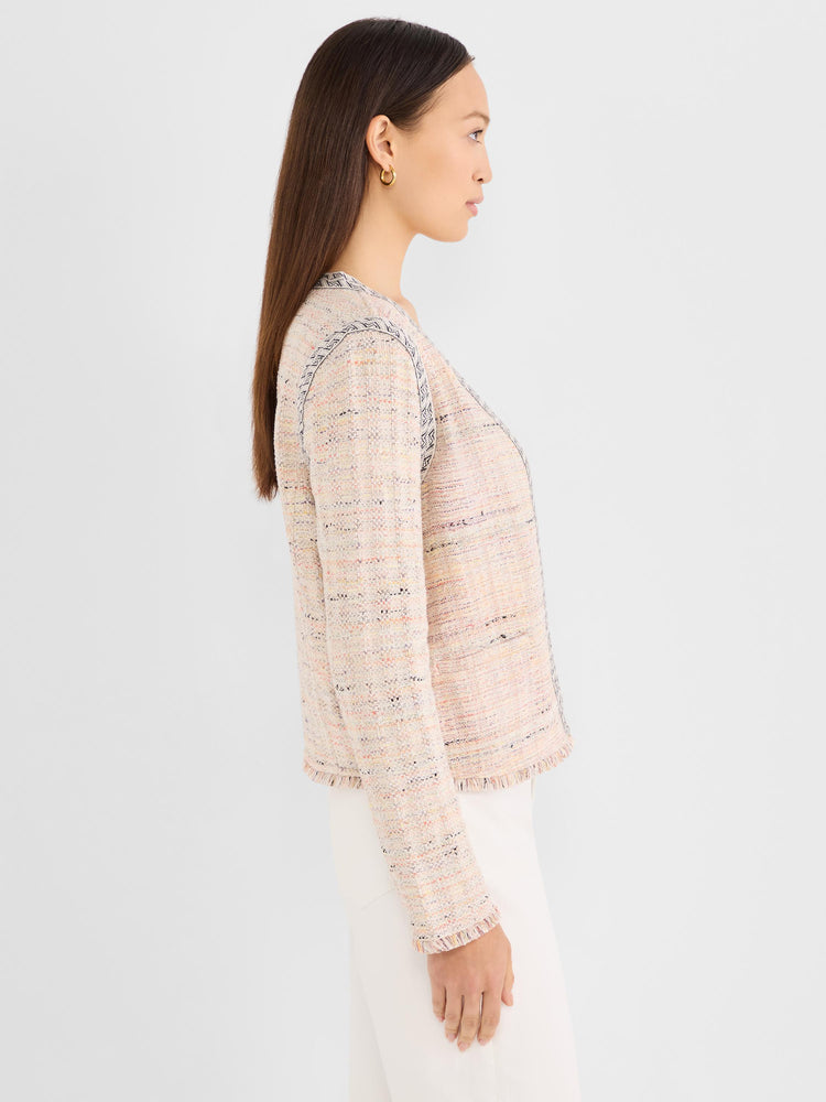 Fitted pink tweed jacket with a cropped length, contrast chevron trim, and subtle frayed edges.