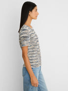 Short-sleeve sweater tee with textured spacedye knit in cream, dark blue, and light blue stripes.