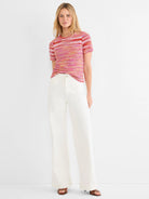 Short-sleeve spacedye tee, textured knit with horizontal stripes in fuchsia, pink, red, orange, and white.