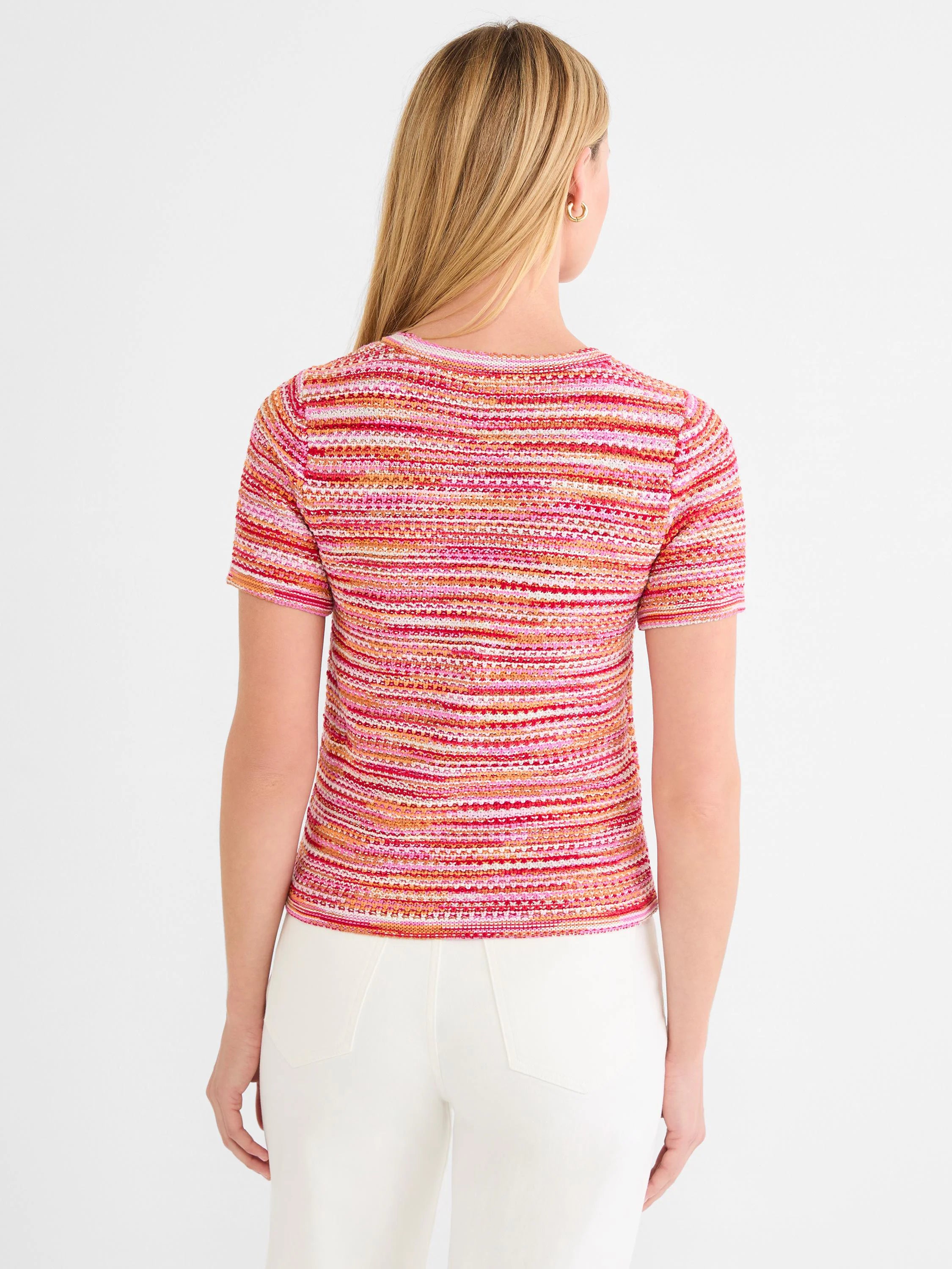 Pink, orange & white spacedye knit tee with horizontal tuck stitch stripes. Model from behind.