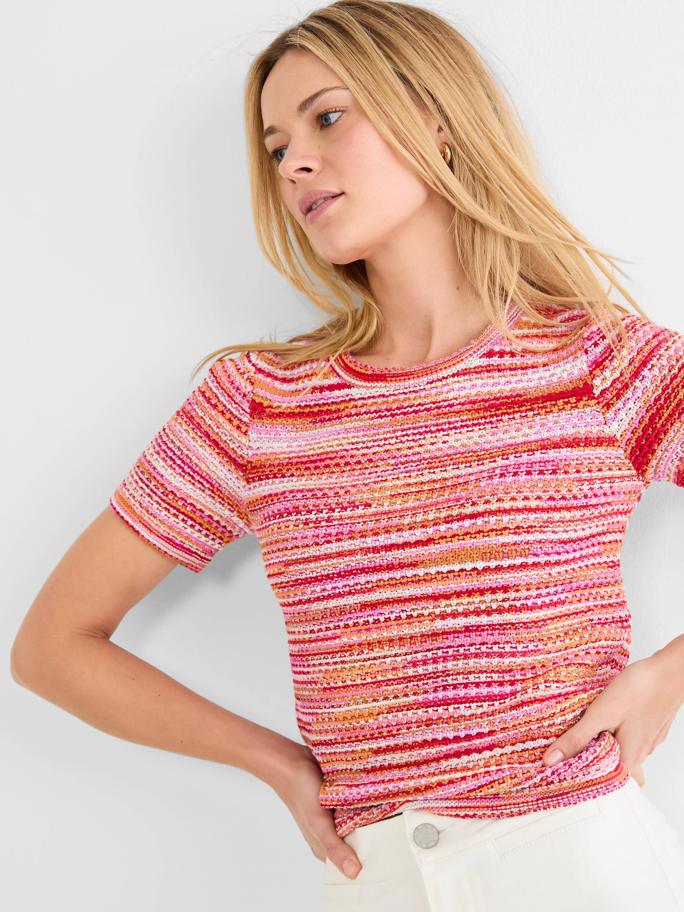 Short-sleeve crew neck sweater tee with textured spacedye knit in horizontal pink, orange, red, and white stripes.