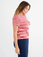 Pink, red, orange & white spacedye knit tee. Short sleeves, crew neck, and subtle tuck stitch texture.