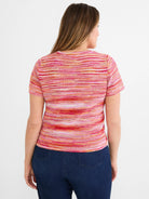 Pink, orange, and white spacedye knit short-sleeve sweater tee with horizontal stripes and tuck stitch texture. Back view.