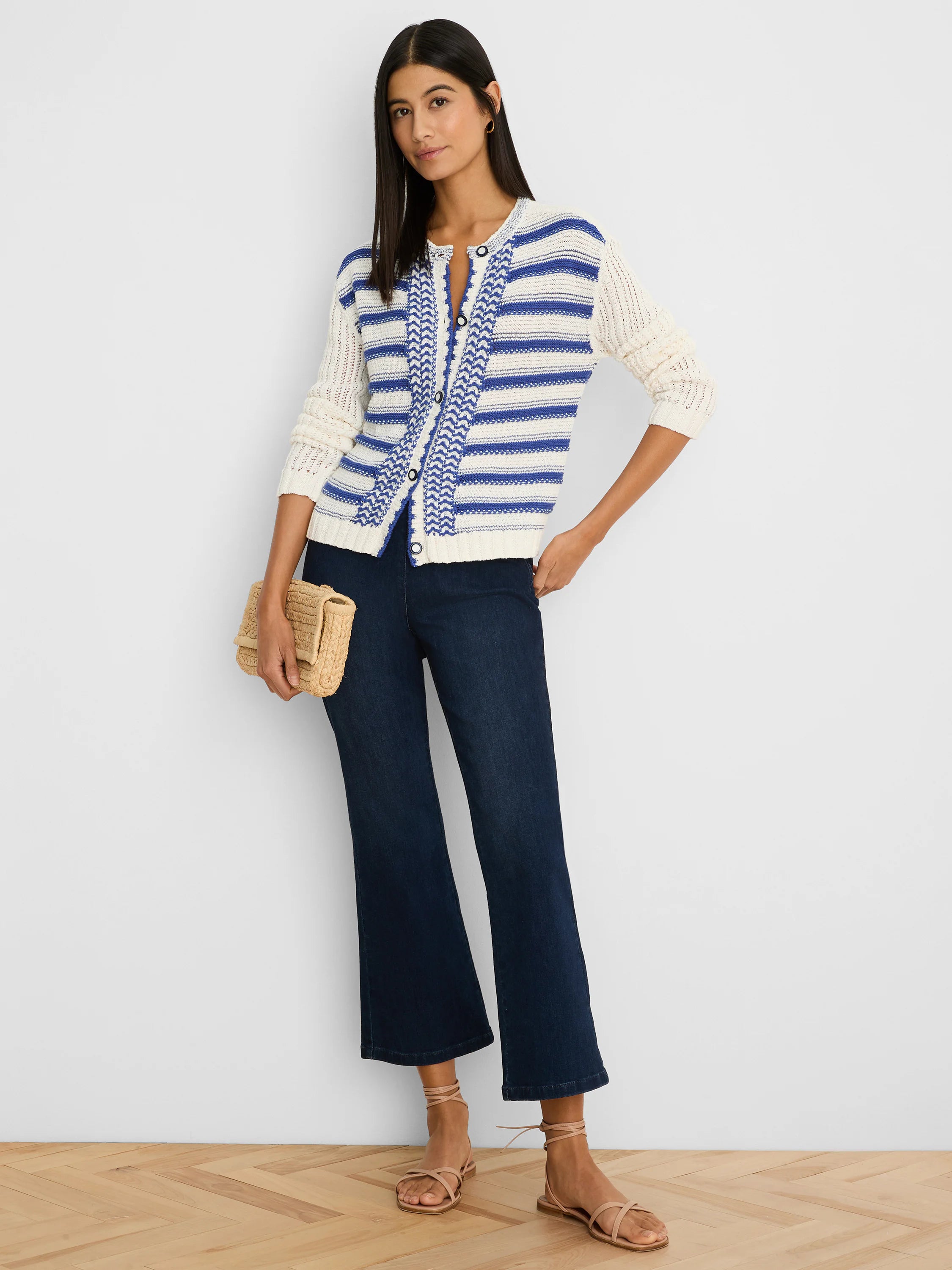 Off-white knit cardigan with horizontal blue stripes and a vertical blue chevron pattern on the front.