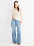 Cream crochet mesh sweater with a polo collar, 3/4 sleeves, and scalloped edges.