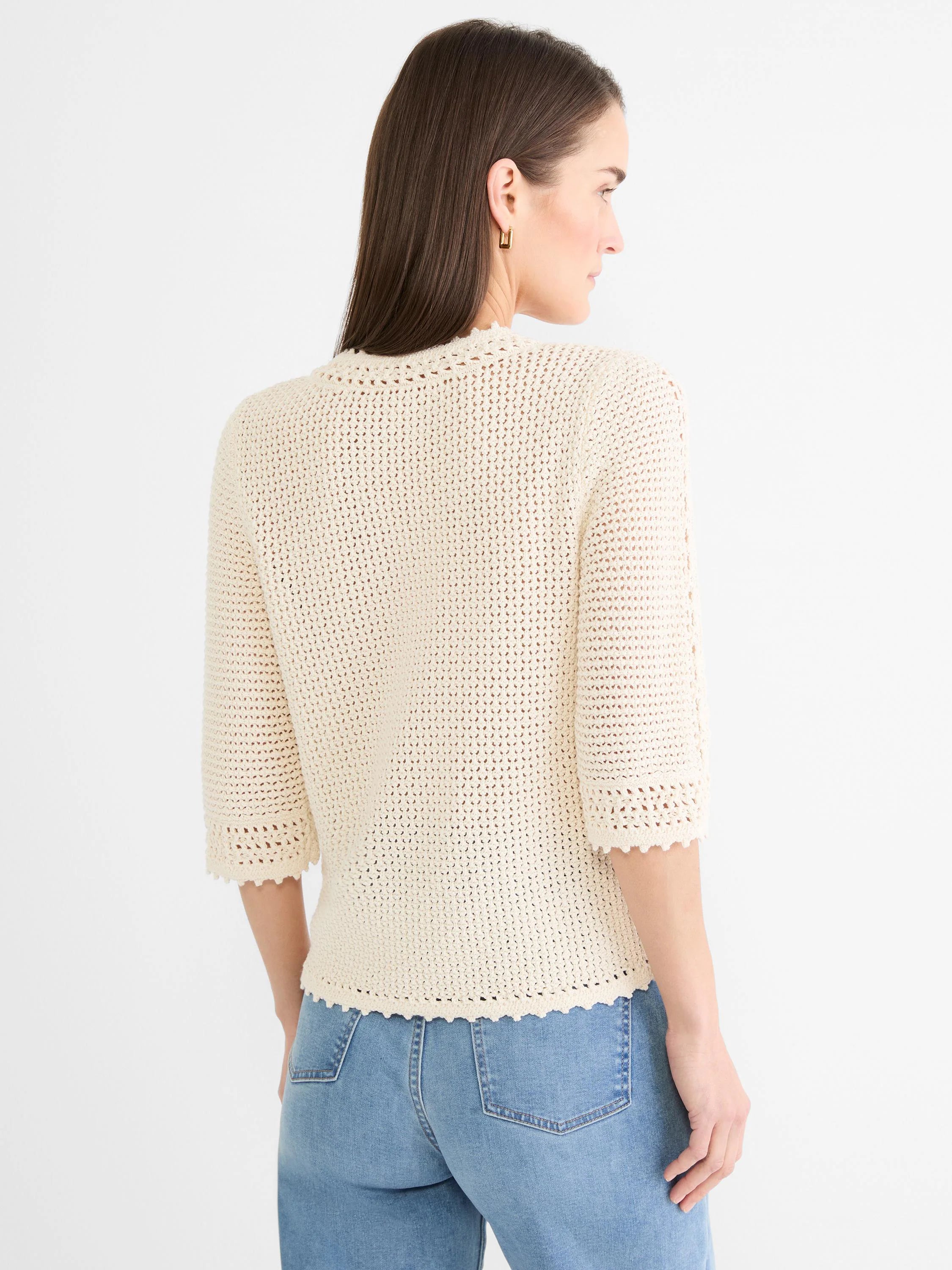 Cream crochet mesh sweater with 3/4 sleeves and scalloped edges, modeled from behind.
