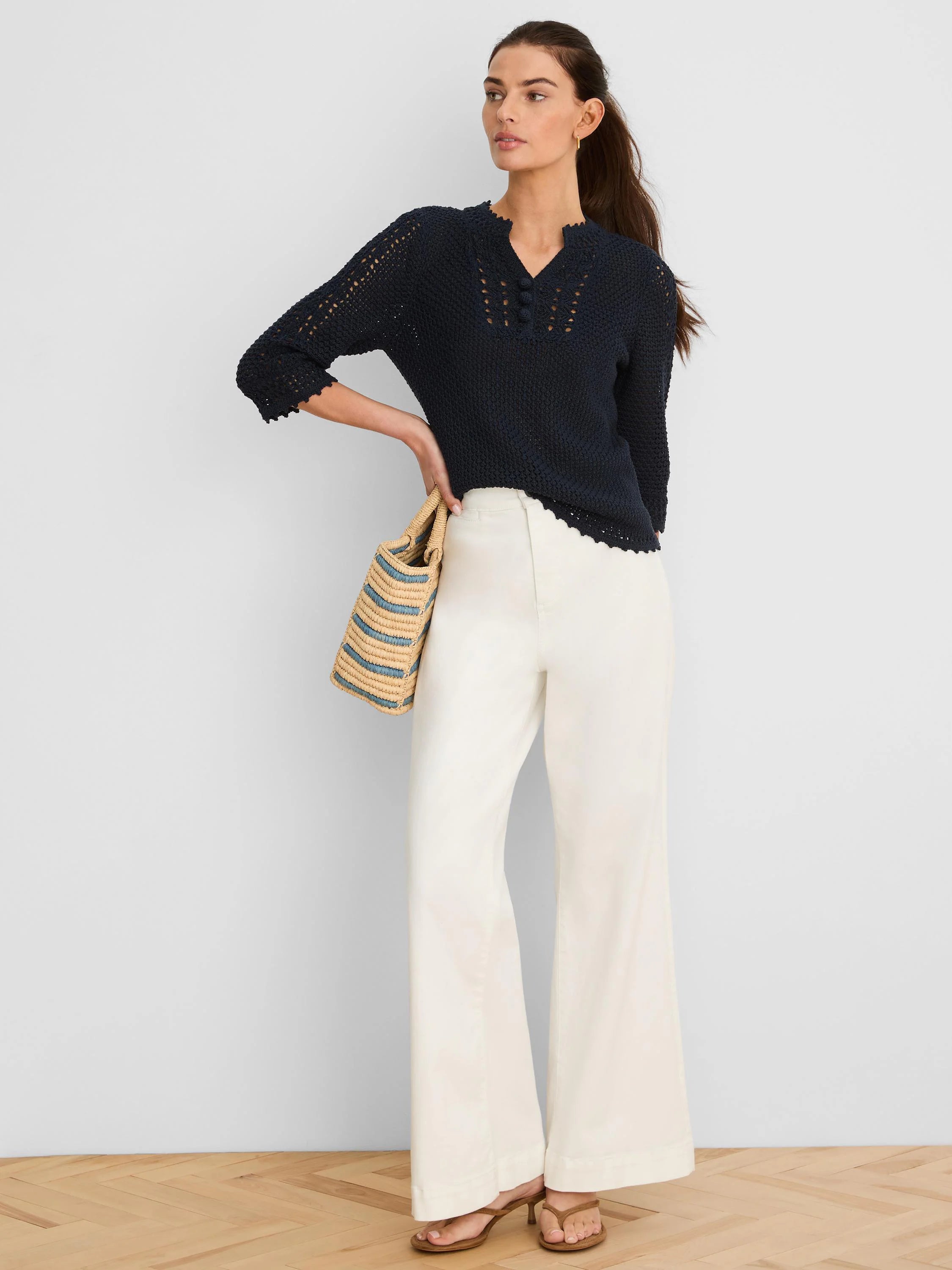 Dark blue V-neck sweater with open crochet mesh, 3 decorative buttons, and scalloped trim.