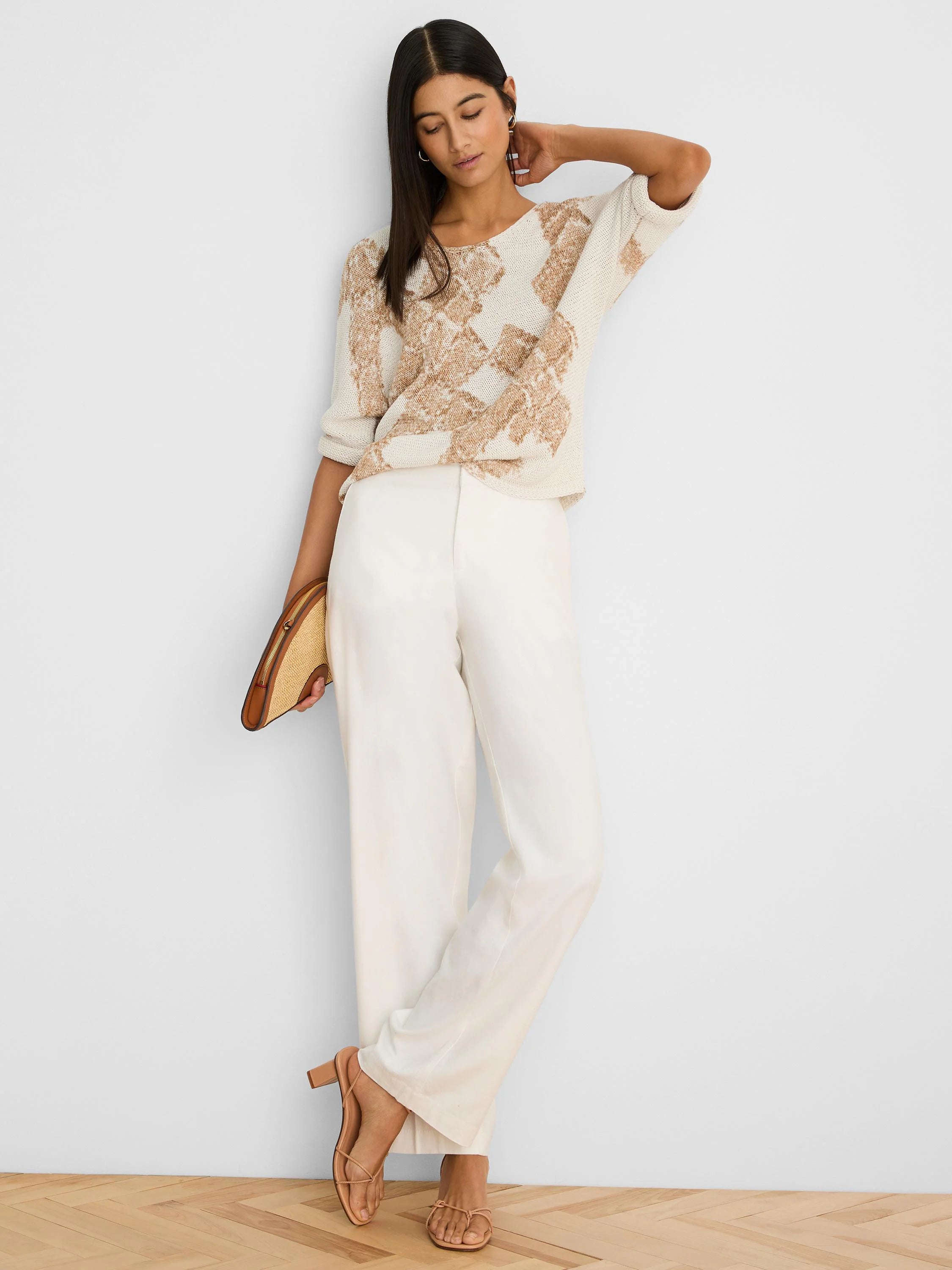 Cream knit sweater with tan abstract cobblestone pattern and short sleeves.