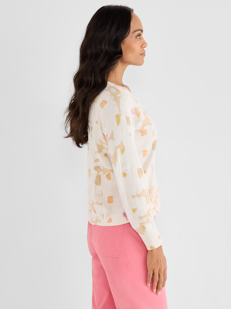 A standard-fit cream sweater with long sleeves showcases an abstract pastel print in warm tones.
