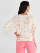 Cream knit crewneck sweater in a regular fit with an abstract pink, yellow, and tan pattern.