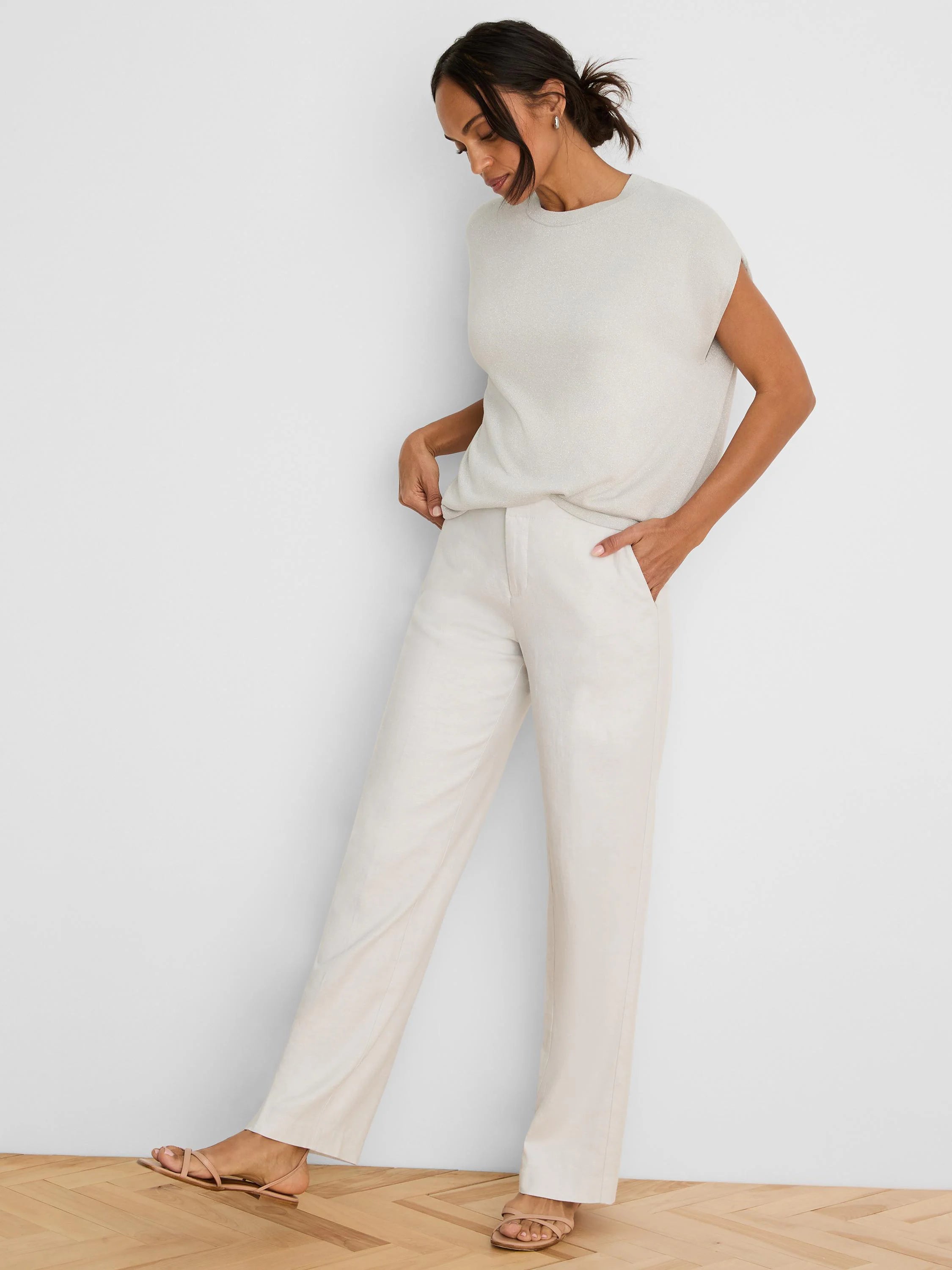 Light beige shimmering sleeveless cocoon sweater, round neck.