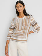 Mixed knit sweater in cream, tan, grey, and brown with striped 3/4 sleeves and a central geometric pattern.