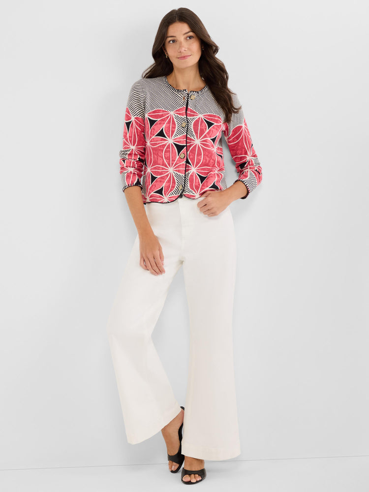 Fitted, cropped cardigan featuring a pink and black floral geometric pattern, contrast piping, and button front closure.