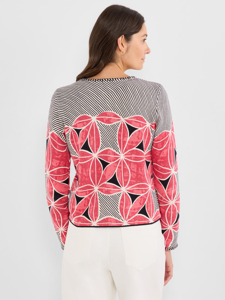 A regular fit knit sweater featuring a bold pink, black, and white abstract floral and stripe design with long sleeves.