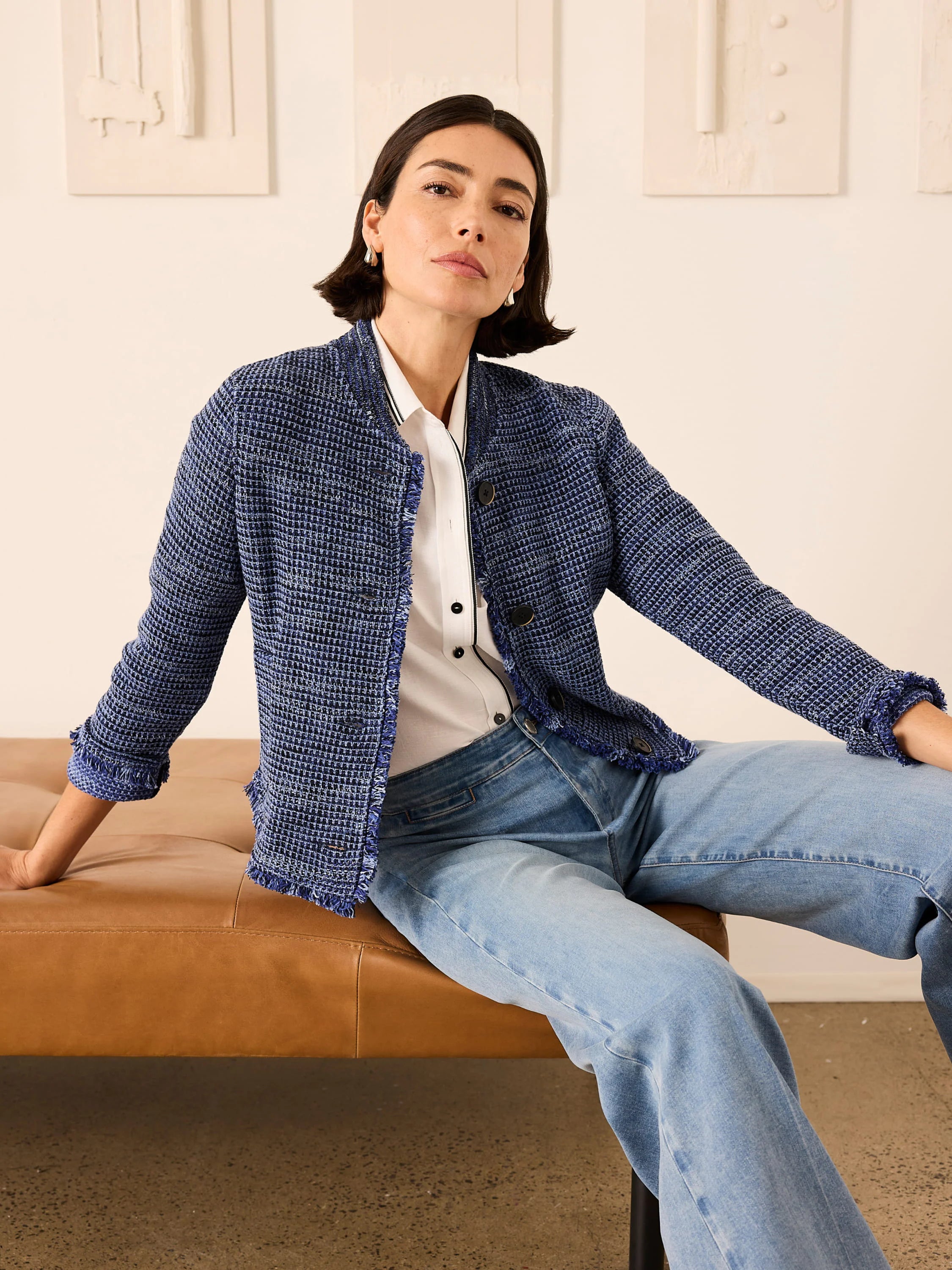 Dark blue textured knit bomber jacket with fringe trim on edges.