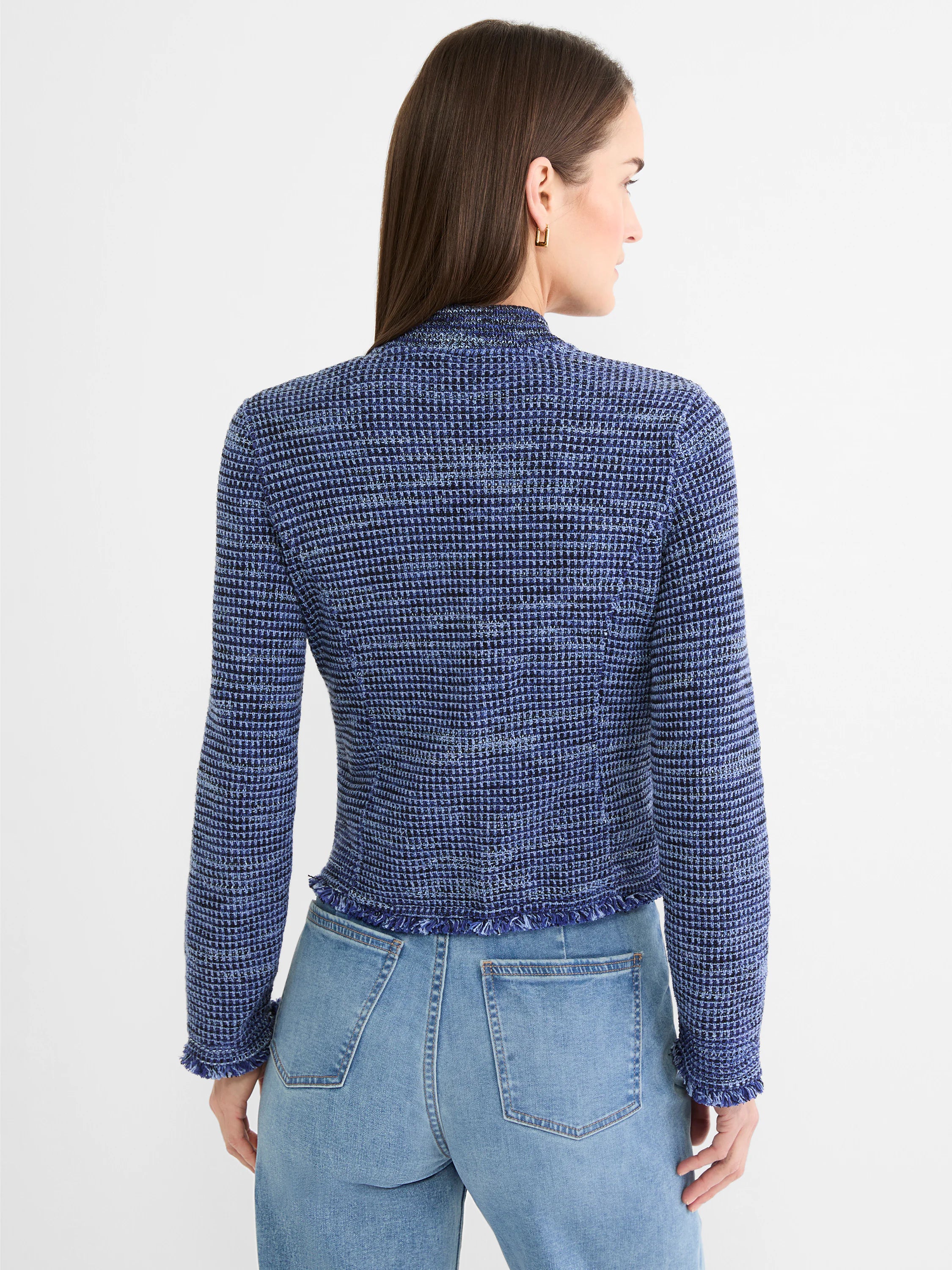 Marled blue knit bomber jacket with fringe on hem and cuffs. Model shown from back.