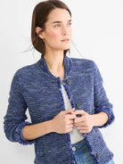 Blue knit bomber jacket with fringe trim on edges and dark buttons.