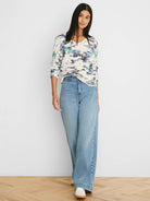Cream pointelle sweater with abstract blue, purple, and green pattern.