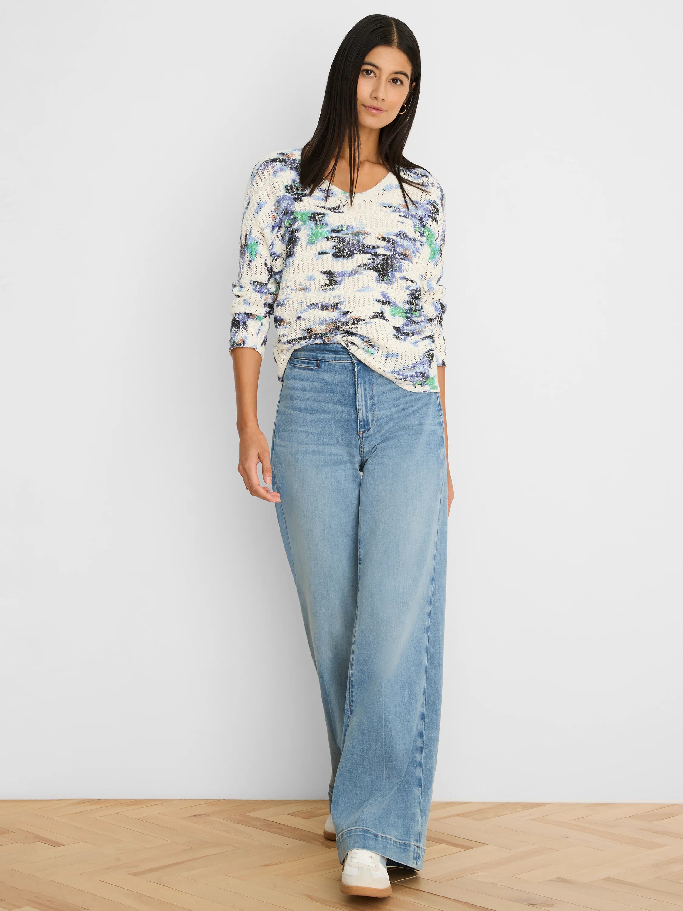 Cream pointelle sweater with abstract blue, purple, and green pattern.