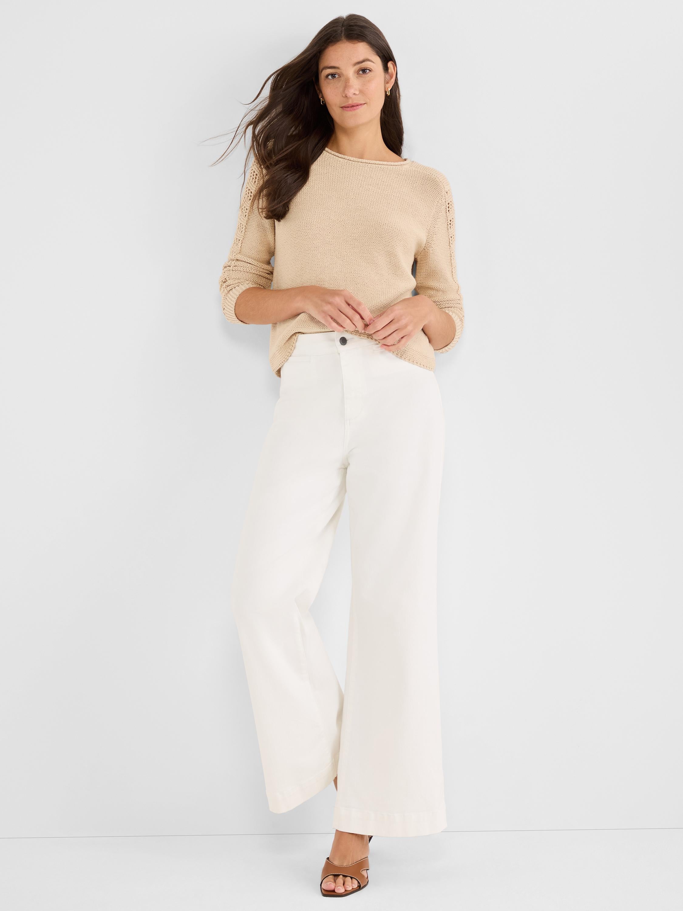 Relaxed tan knit sweater with pointelle three-quarter sleeves and a boat neck, styled tucked into high-waisted white.