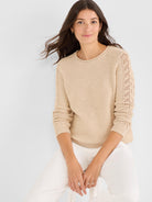 Beige relaxed knit sweater with crewneck and decorative lace eyelet sleeves.