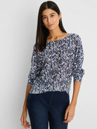 Indigo crosshatch sweater with white and black zigzag pattern, boat neck, and 3/4 sleeves.