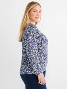 Long-sleeve sweater with a jagged indigo and light blue crosshatch pattern on a white ground.