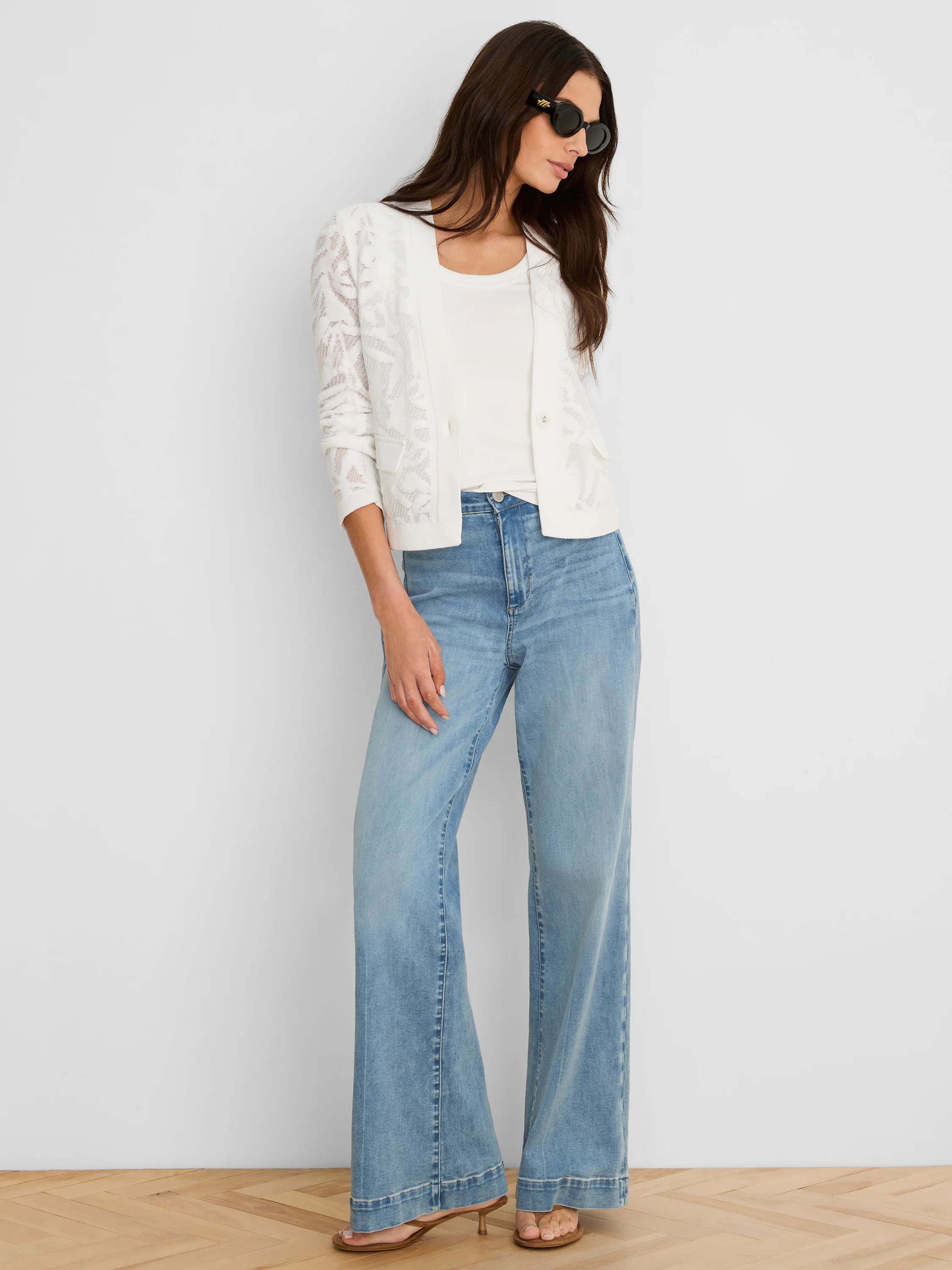 White, slightly cropped open-front jacket with an all-over floral lace pattern and 3/4 length sleeves.