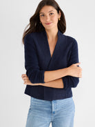 Cropped navy textured knit jacket with a structured fit and wide shawl lapels.